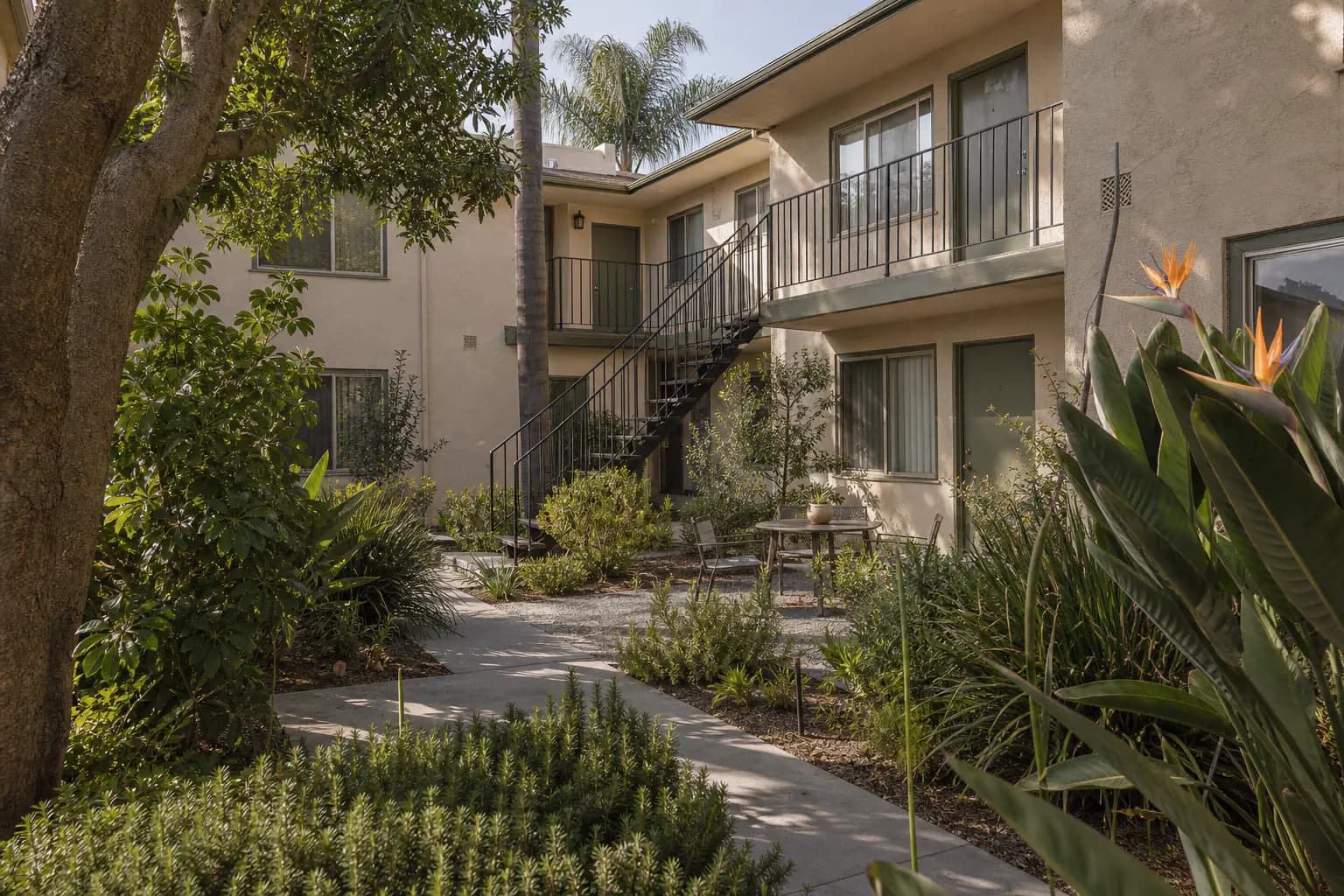 Finished landscaped Southern California apartment courtyard with exterior stairs